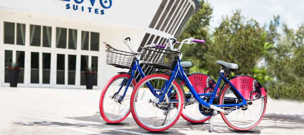Two Nuvo bicycles parked in front of the Nuvo Suites entrance