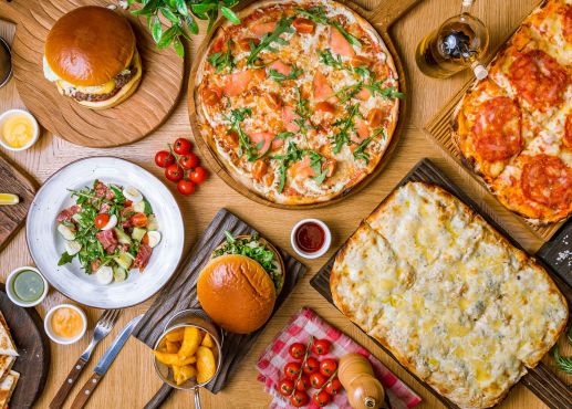 american food in a table, burgers, pizza, etc