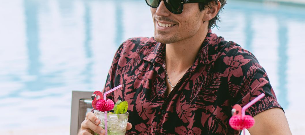 man at the pool with drinks