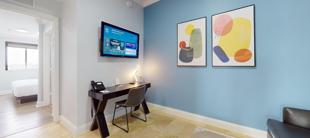 two bedroom suite room 2 with tv and desk